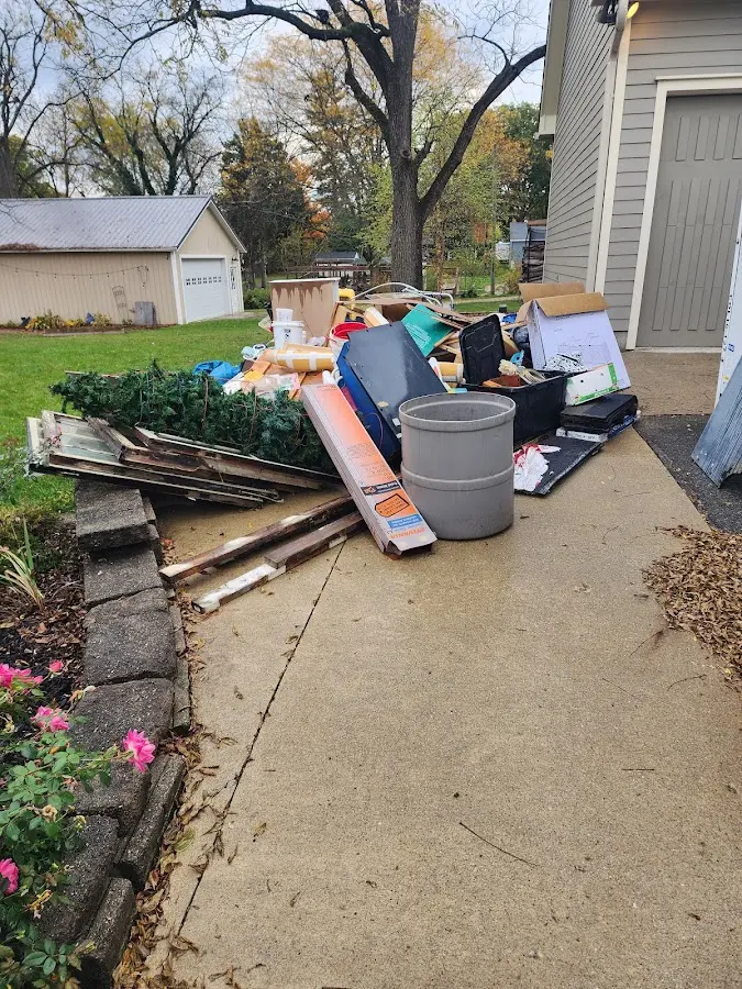 Dumpster being loaded with debris for 12 Yard Dumpster Rental in Beaver Falls